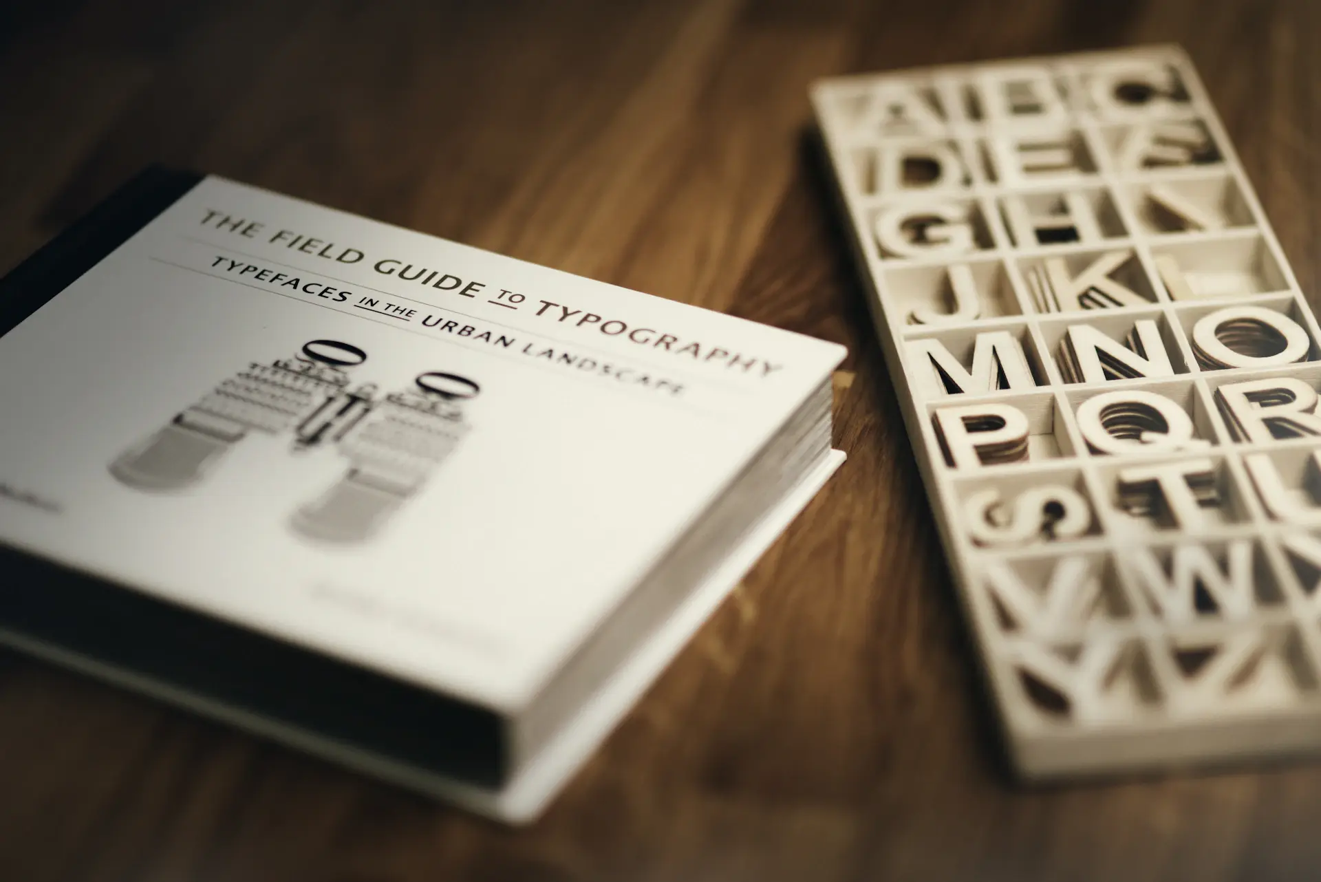 Typeface specimens laid out across a designer's desk