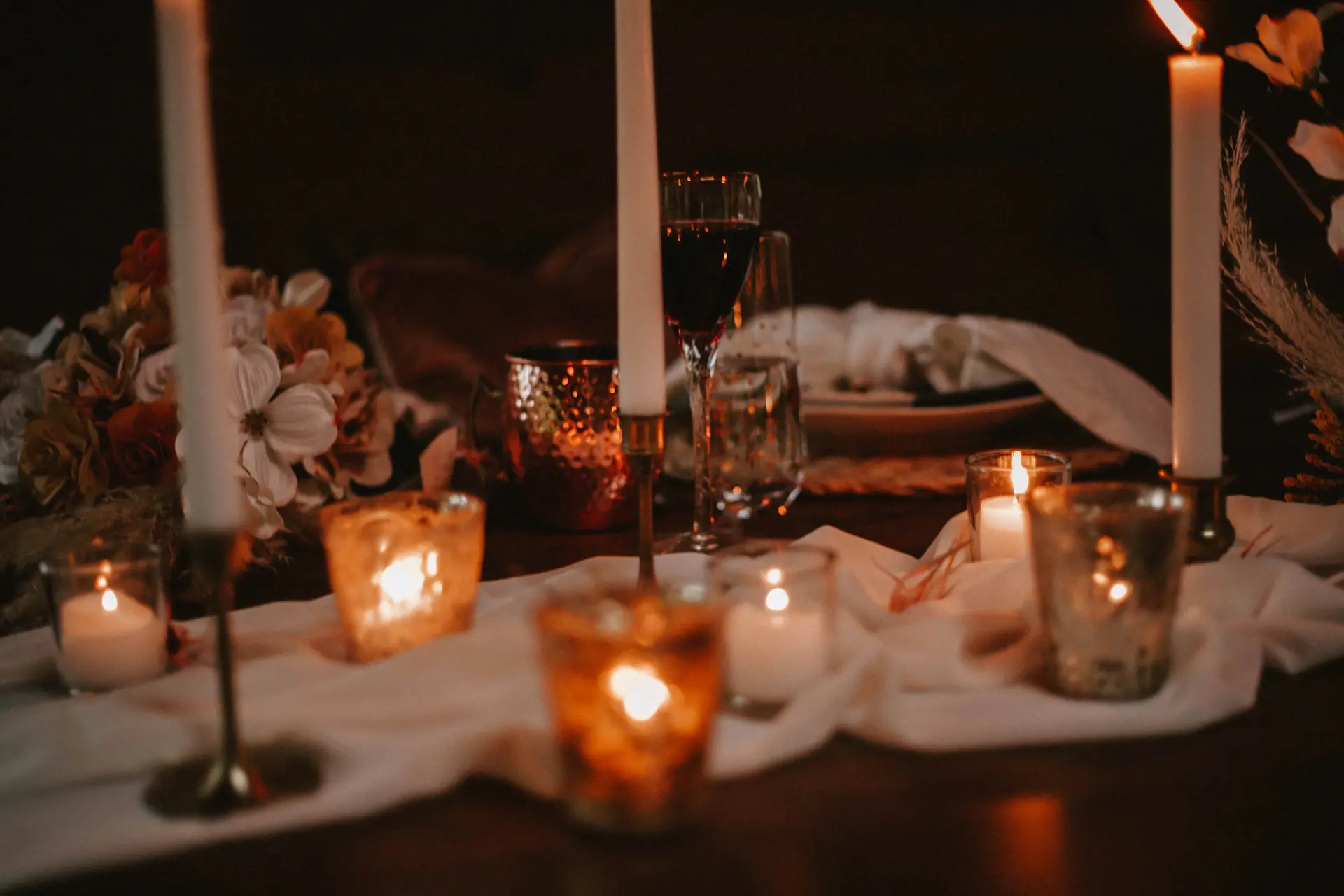 Soft candlelit reception detail in warm champagne tones