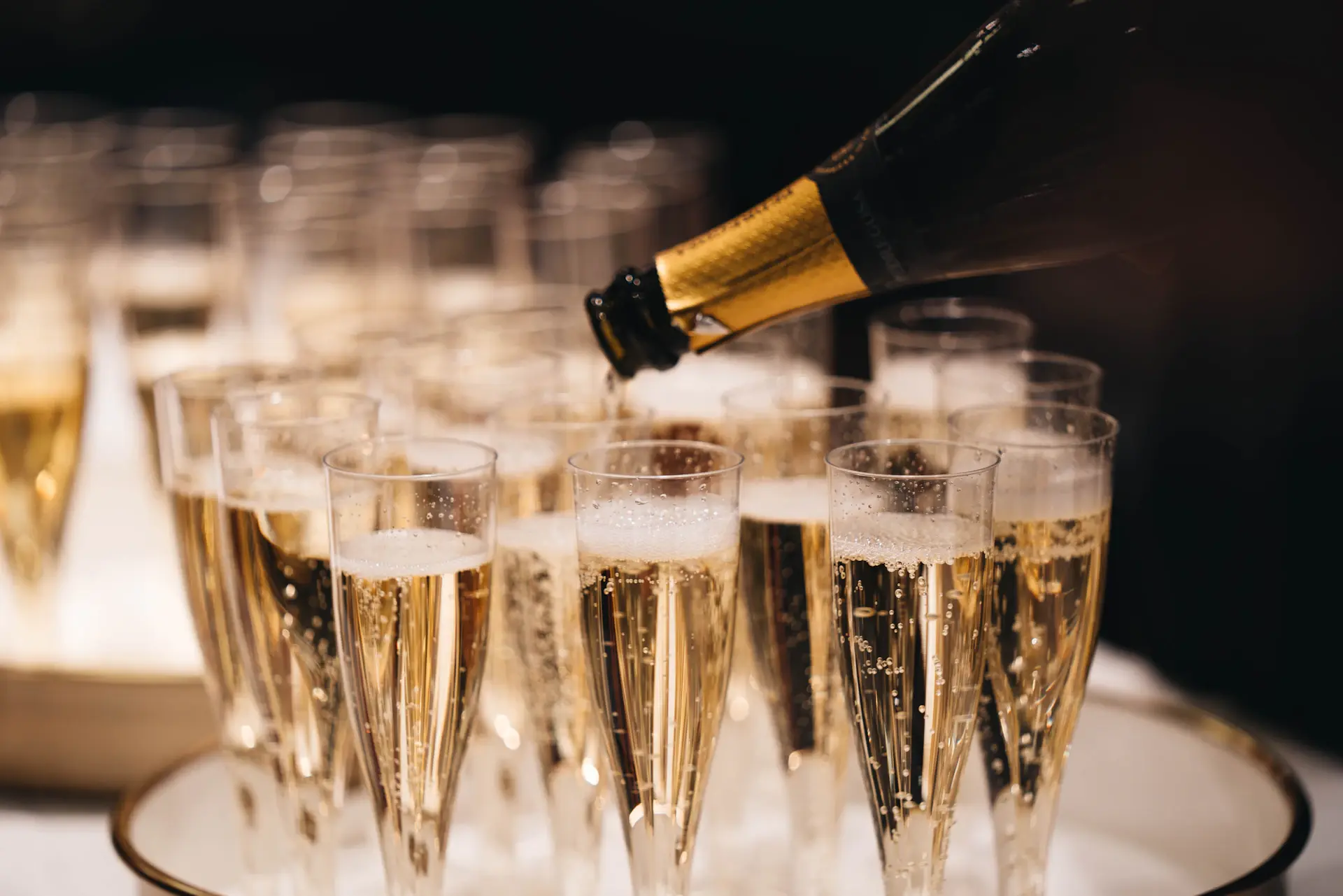 Champagne being poured into a crystal coupe