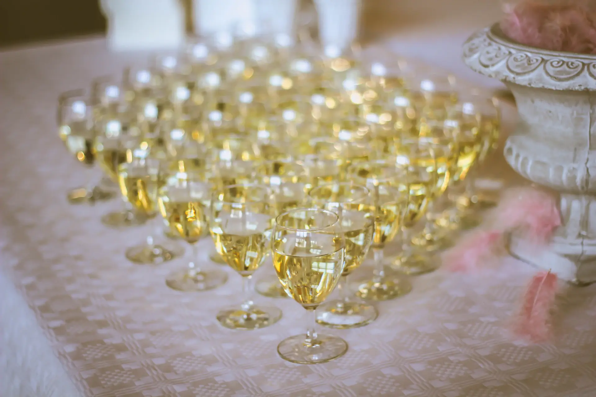 Champagne coupes catching warm candlelight