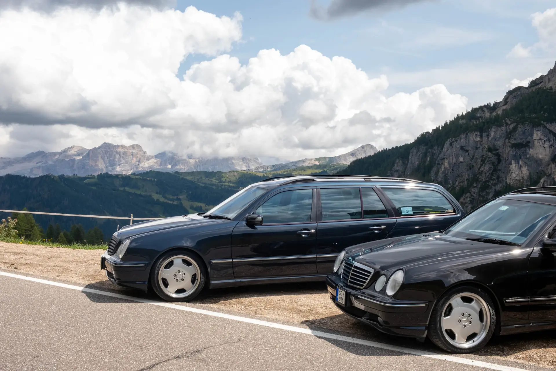 A luxury car on a winding mountain pass in the Dolomites