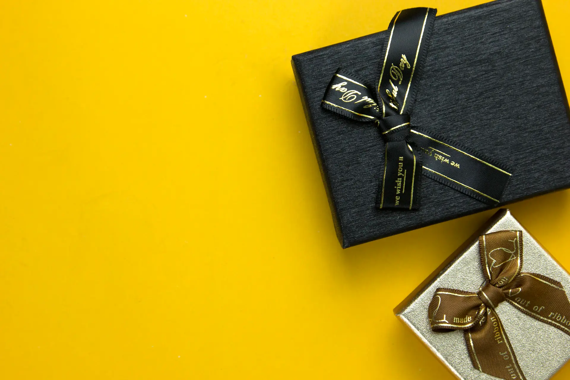 A premium gift box tied with a champagne-gold ribbon, presenting a rare bottle
