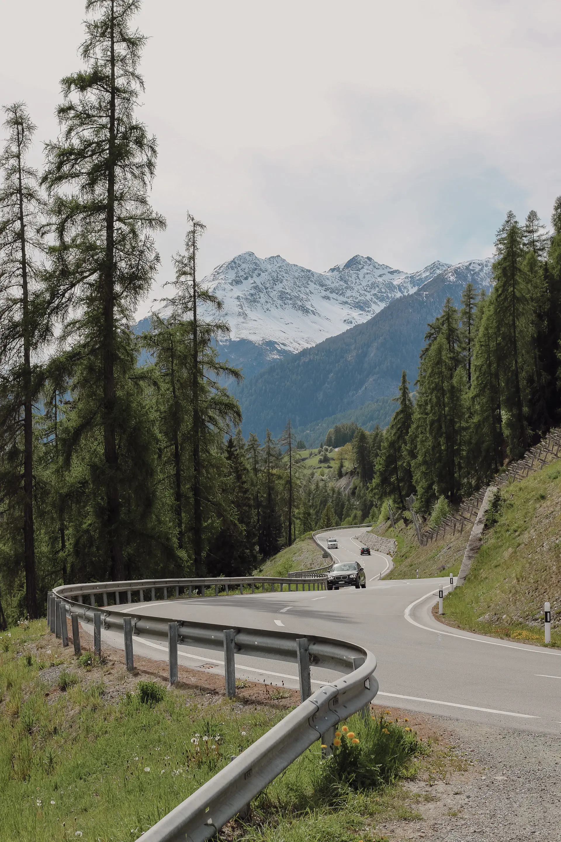 Luxury grand tourer on a winding alpine mountain road