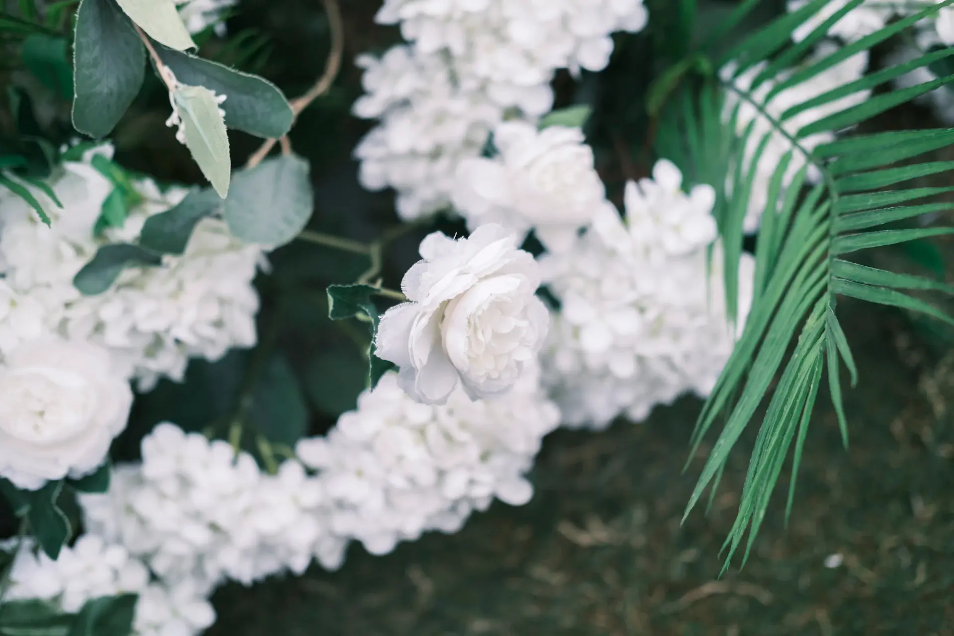 Floral stage backdrop for a ceremony
