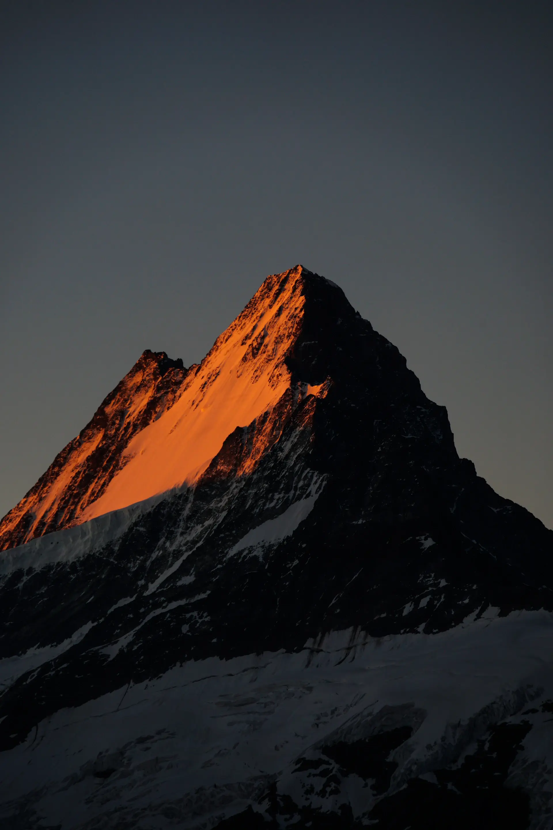 Warm sunset glow on the highest faces of a range