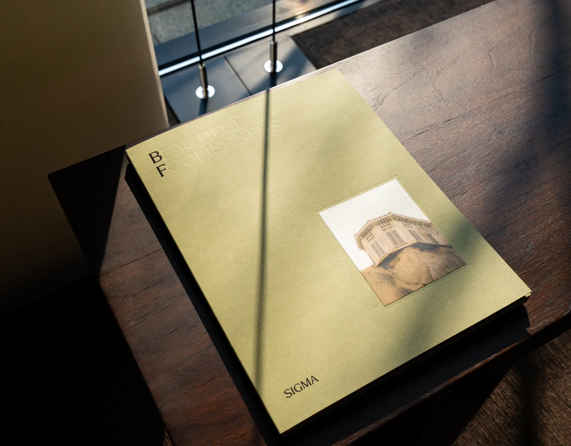 A typographic specimen sheet on a sunlit desk