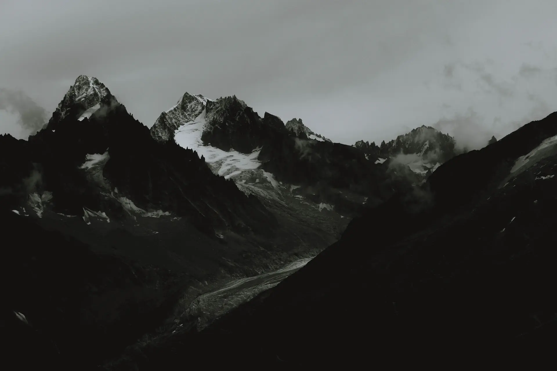A faint cinematic landscape of mountains dissolving into mist