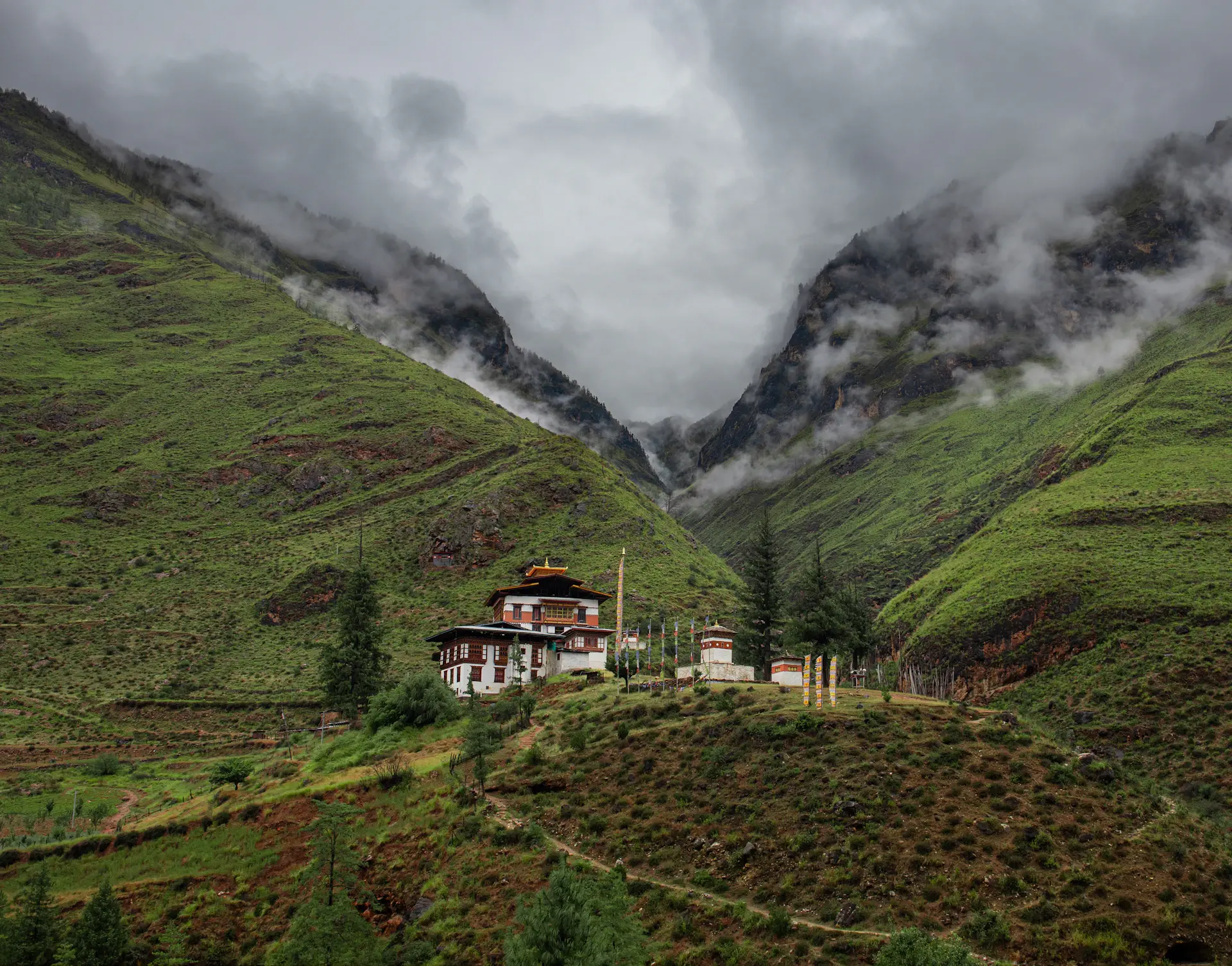 A cliffside monastery rising through Himalayan mist at dawn