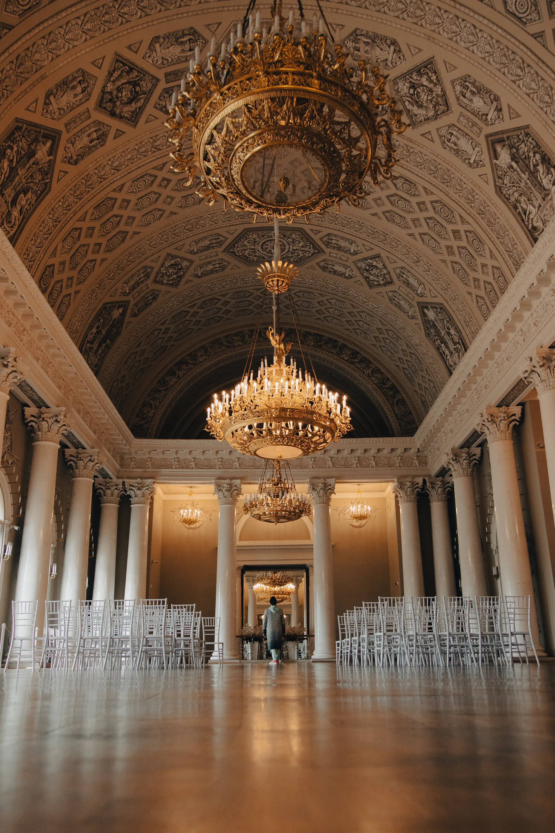 Symmetrical ballroom aisle lined with candles