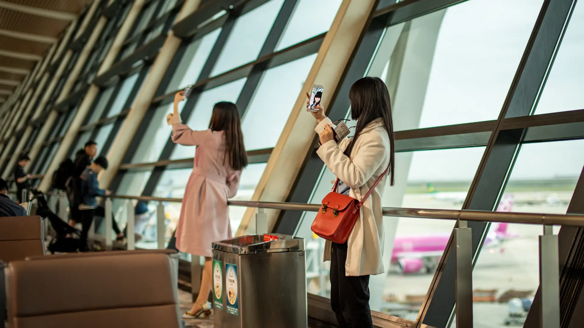 Student holding passport and boarding pass at an elegant airport terminal