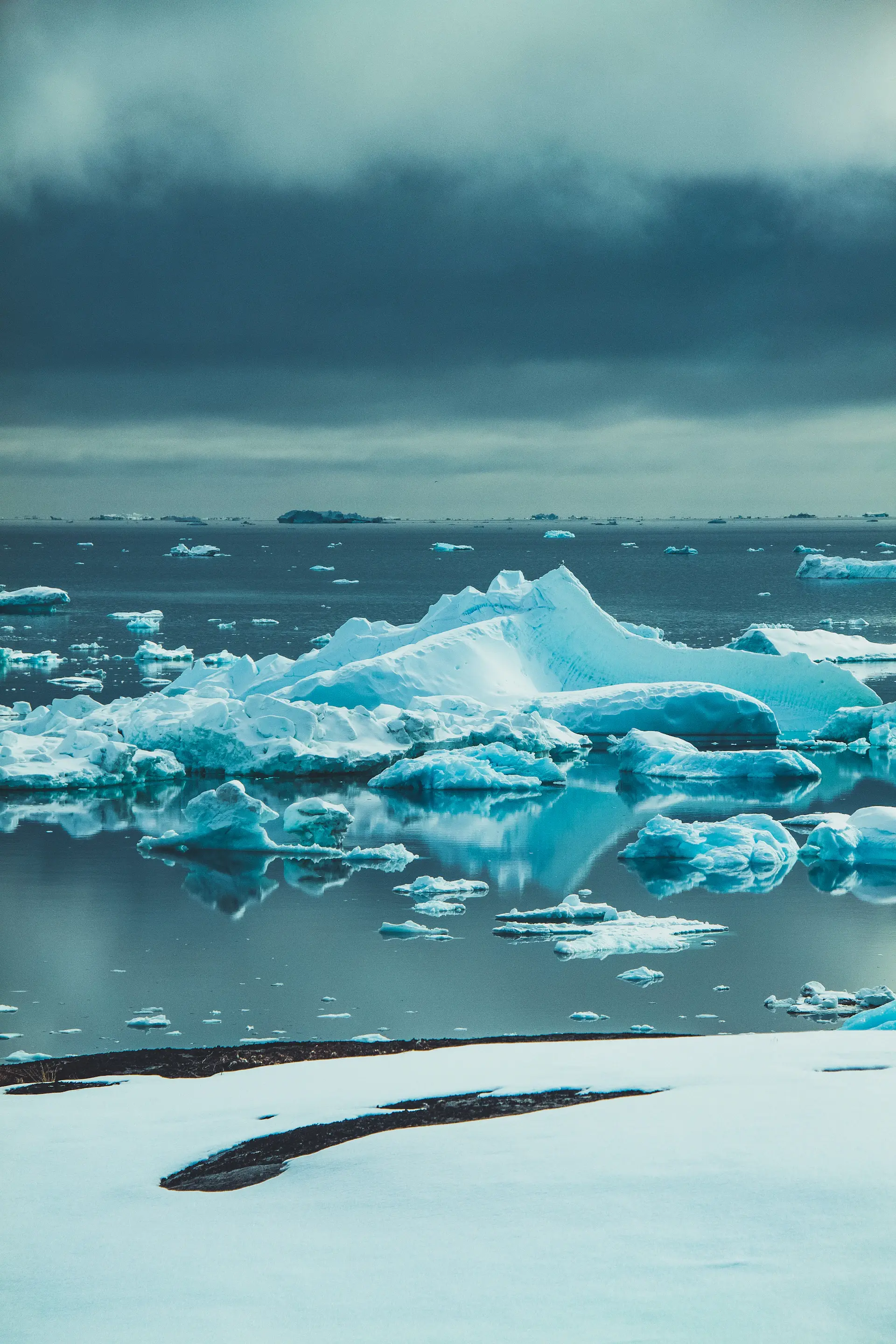 Glacial blue ice under a pale Arctic sky