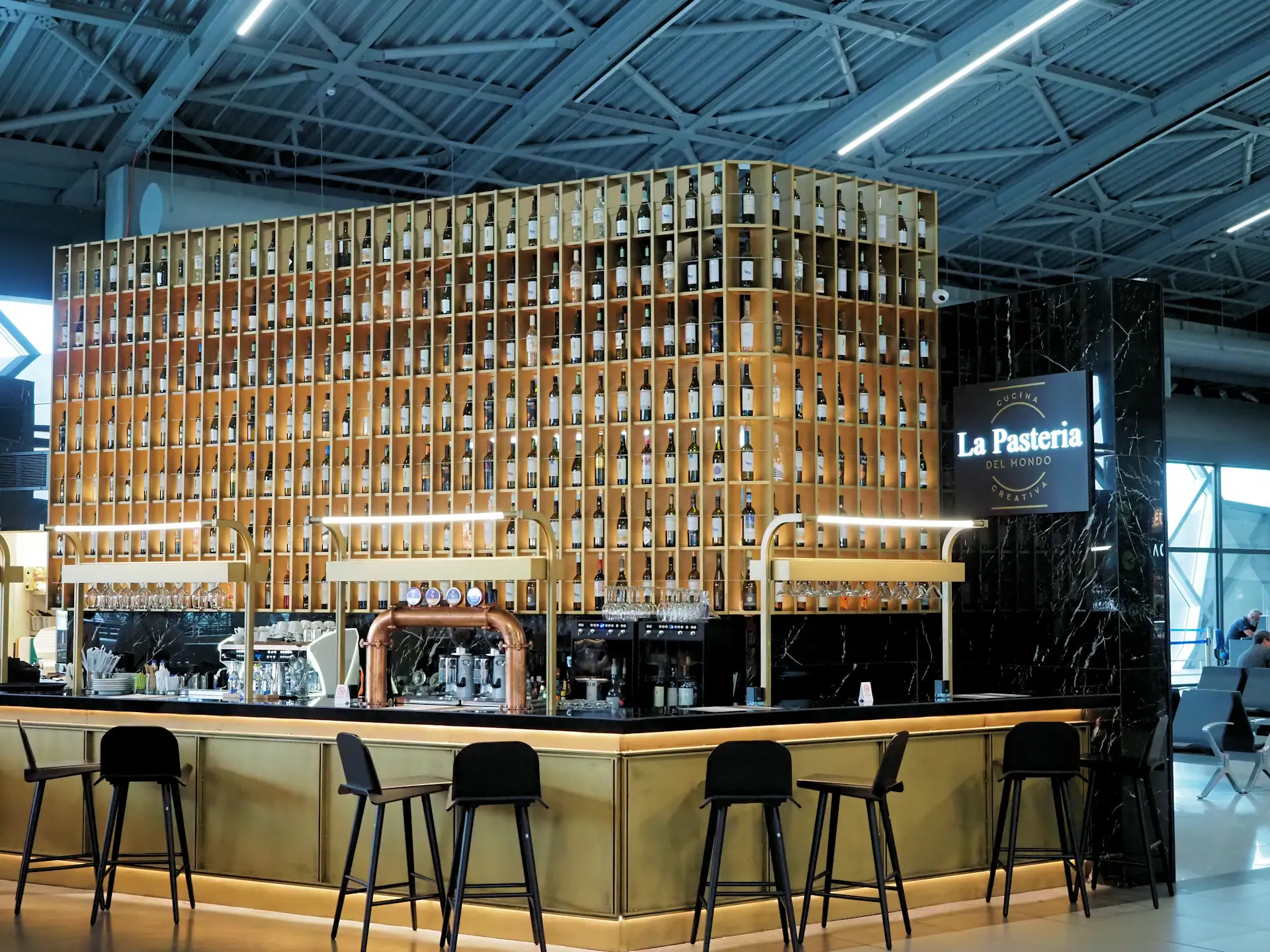 Espresso bar with warm wood and brass