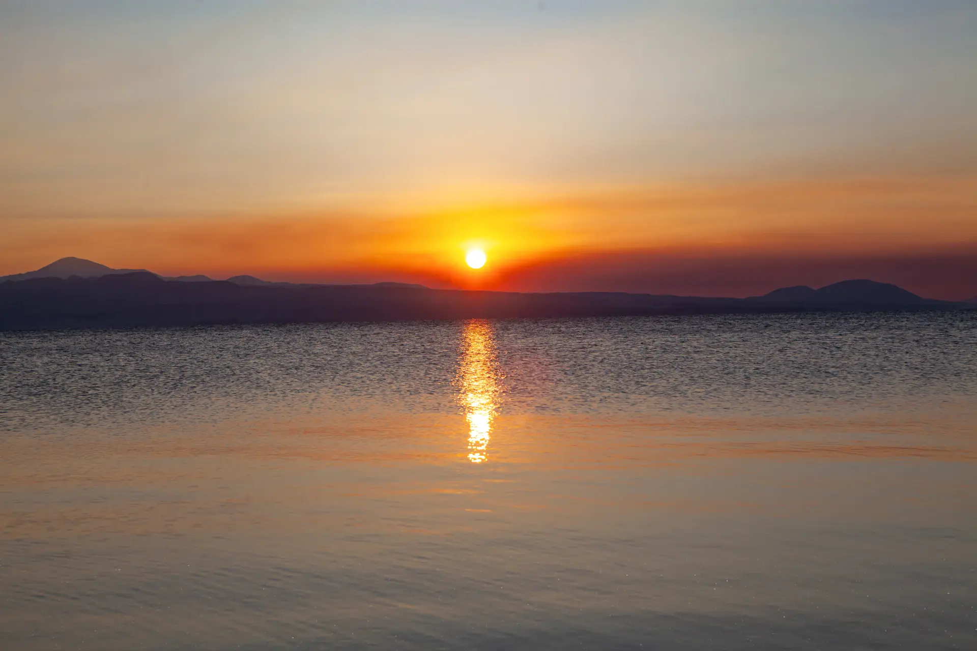 Golden dusk light across a wide lake