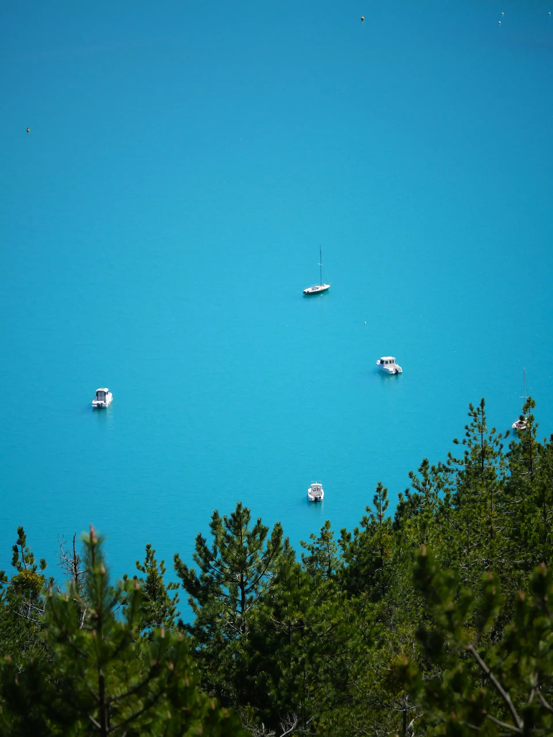 Sailing yacht anchored in a remote turquoise bay