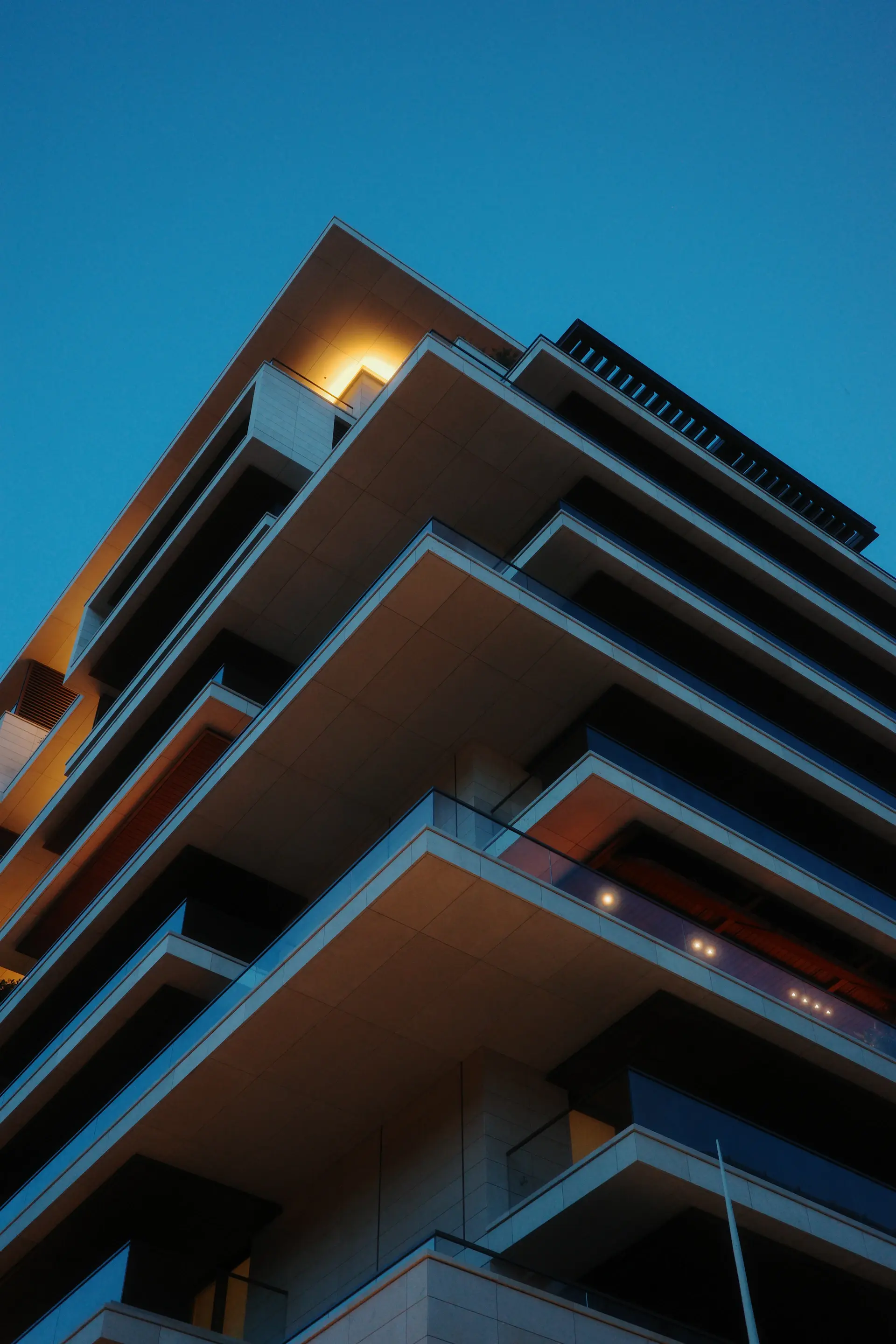 Tall cinematic view of a luxury residence facade at dusk