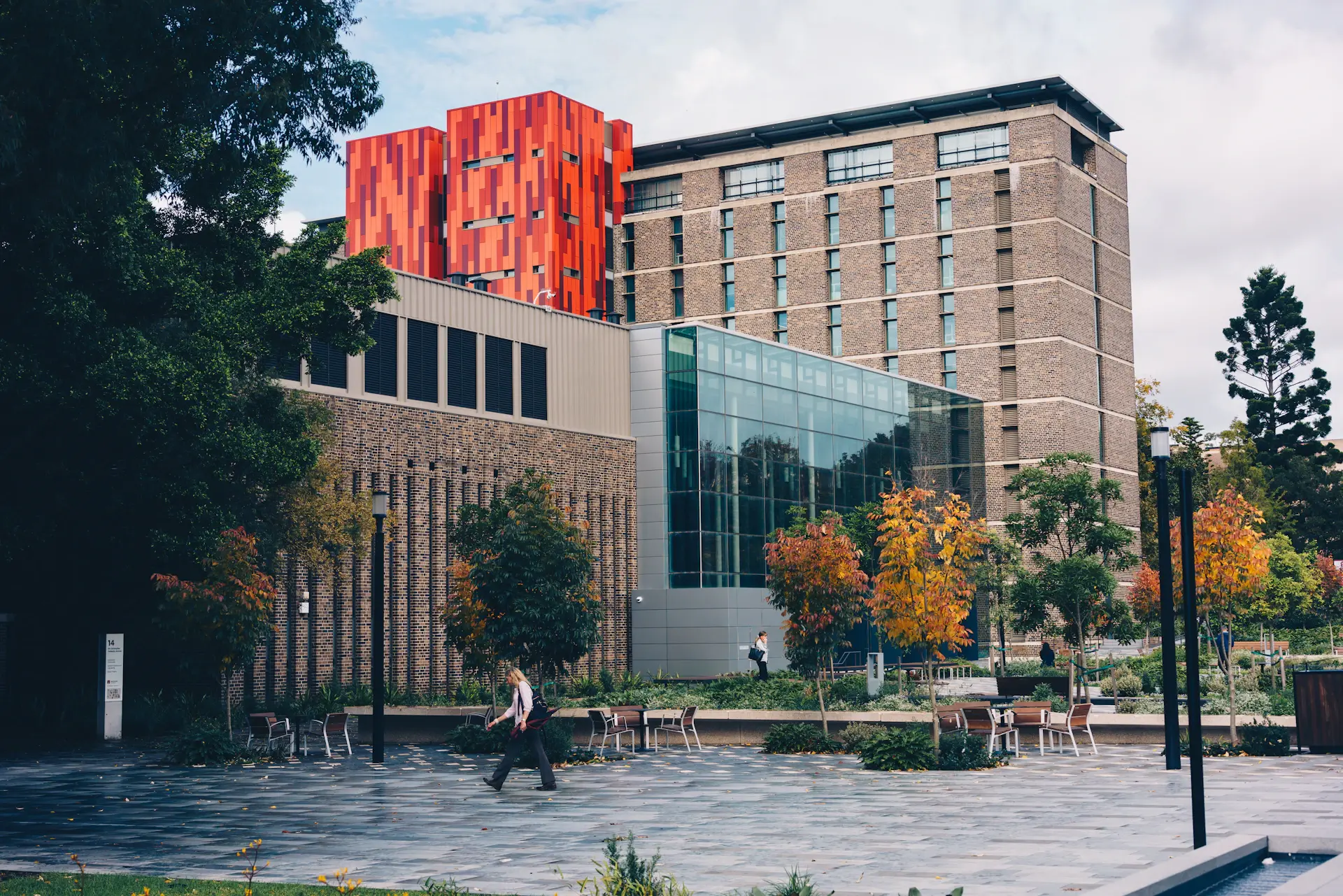 Elite Pathways advisor walking with a student across a university courtyard