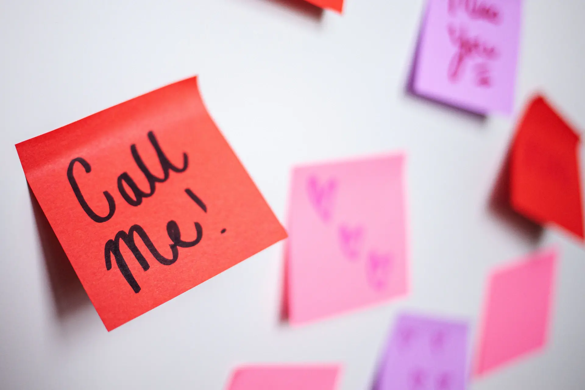 Remote team on a video call with sticky notes on a wall