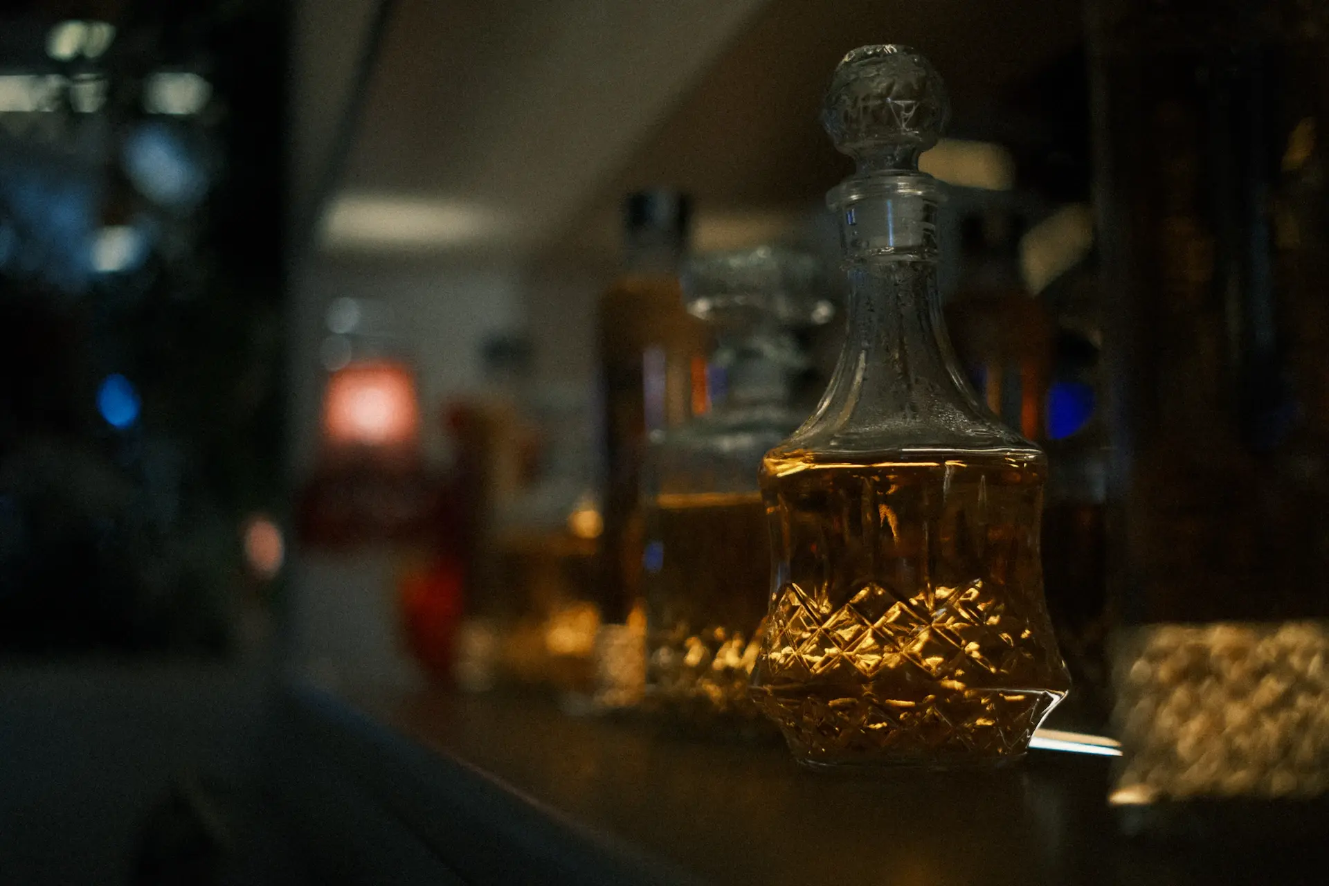 Extreme close-up of amber spirit swirling in a crystal tasting glass