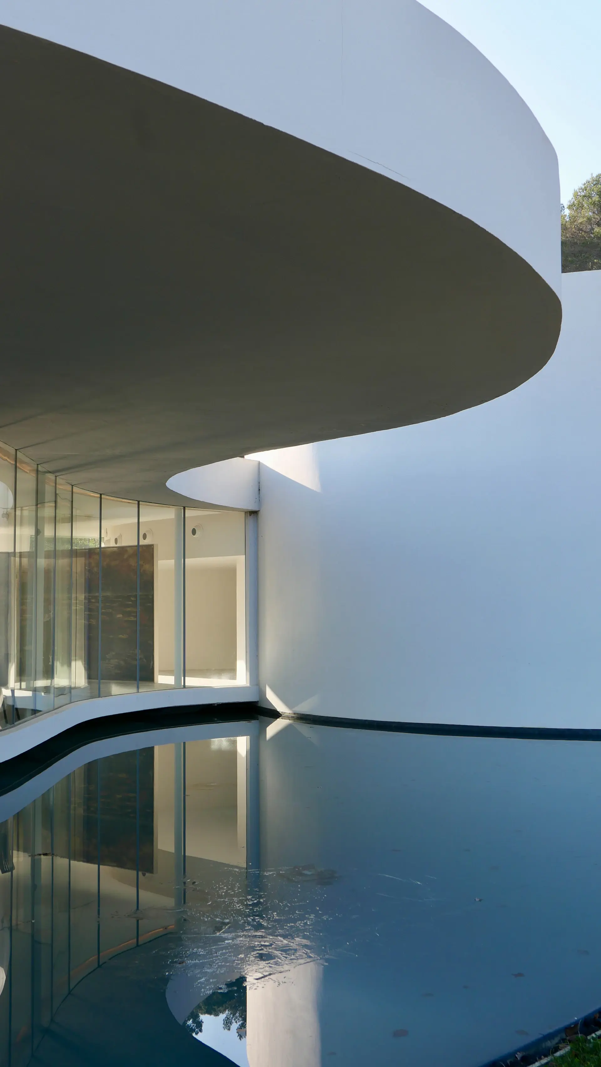 Contemporary villa with reflecting pool and glass facade